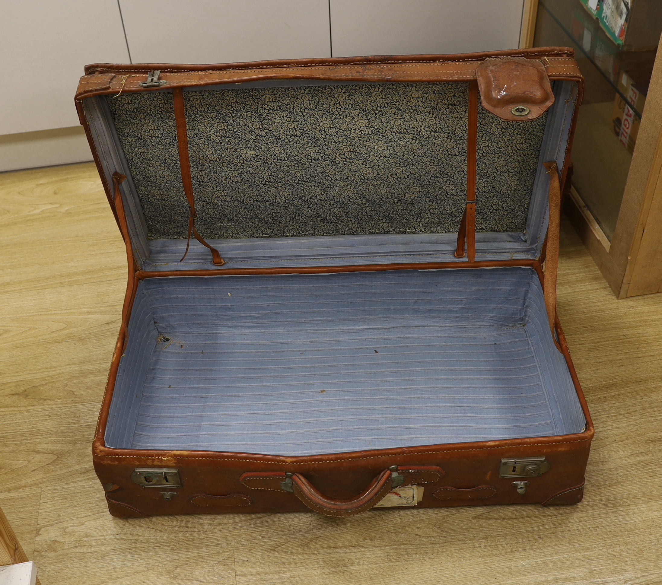 A pair of large brown leather suitcases, 81cm wide, 47cm deep